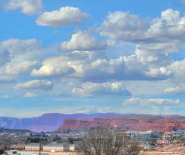 View to the northwest of the red sandstone bluff overlooking St. George with Snow Canyon State Park in the distance.