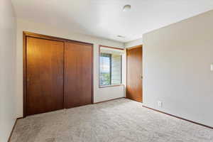 Unfurnished bedroom featuring a closet and carpet floors