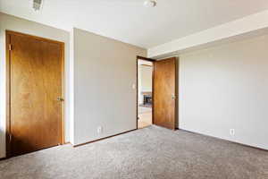 Unfurnished bedroom with a closet and carpet flooring