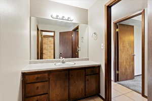 Bathroom featuring tile floors and vanity