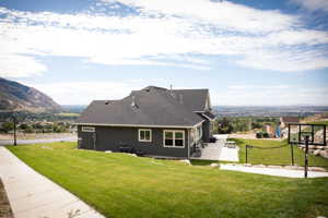 Exterior space with a mountain view and a lawn