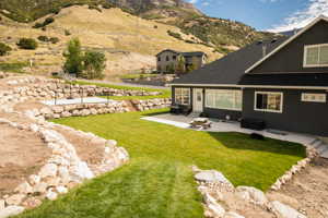 View of yard with a patio and a mountain view