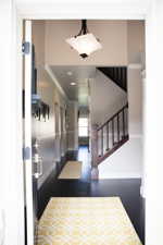 Entrance foyer with dark hardwood / wood-style floors and ornamental molding