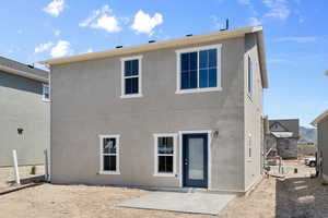 Rear view of house featuring a patio