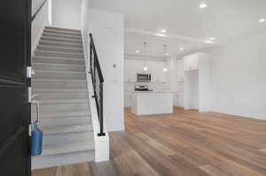 Stairway featuring light hardwood / wood-style flooring