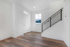 Entrance foyer with hardwood / wood-style flooring