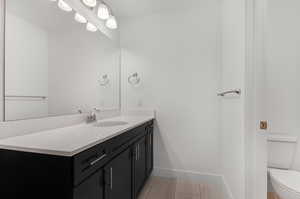 Bathroom with vanity, toilet, and tile floors