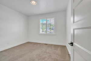 View of carpeted spare room