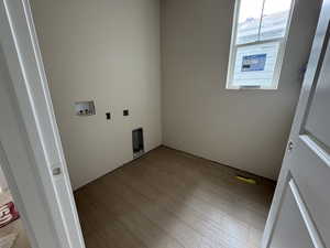 Clothes washing area featuring washer hookup, laundry area, and LVP floors