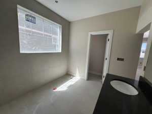 Primary bathroom, double vanity, quartz countertops, tile floors, tile accent wall, and tub (not installed yet)