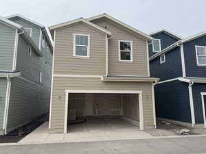 View of back of home with a garage