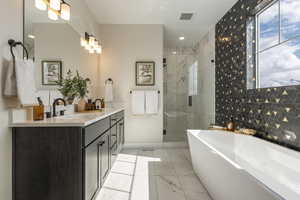 Model home - primary bathroom with a soaking tub, double vanity, and walk-in shower
