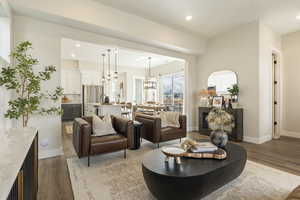 Model home - Living area featuring tall baseboards, LVP flooring, and recessed lighting