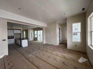 View of unfurnished living room, kitchen and dining area