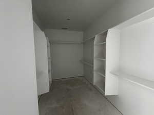 Primary bedroom walk in closet