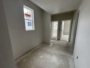 Hallway featuring plenty of natural light and space for office or media area.