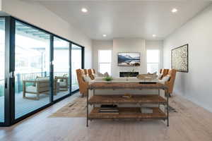 Dining space with light hardwood / wood-style flooring and a healthy amount of sunlight