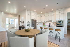 Dining space featuring sink and light wood-type flooring