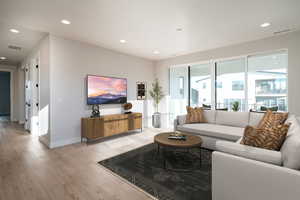 Living room with light hardwood / wood-style flooring