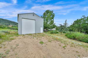 Exterior space featuring a second garage with workshop and a mountain view