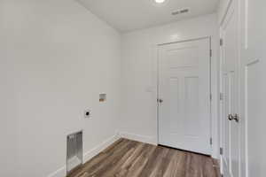 Laundry room featuring washer hookup, hookup for an electric dryer, and dark wood-type flooring