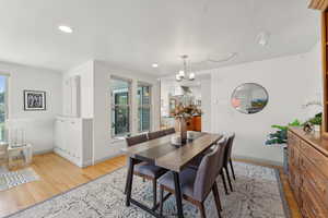 Dining area featuring an inviting chandelier and light hardwood / wood-style flooring