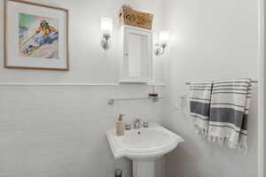 Bathroom featuring tile walls and sink