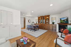 Living room featuring light hardwood / wood-style floors and a high end fireplace