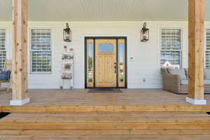 View of exterior entry featuring a porch