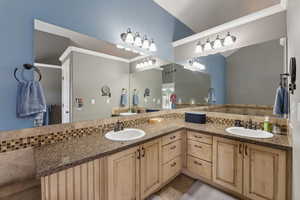 Bathroom with ornamental molding, dual sinks, tile floors, and large vanity