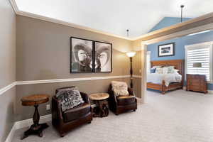 Bedroom featuring ornamental molding, carpet floors, and vaulted ceiling