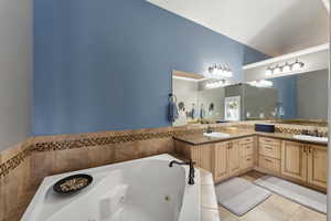 Bathroom with double vanity and tile floors