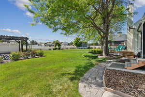 View of yard featuring a pergola and a playground