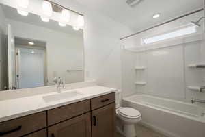 Full bathroom with bathtub / shower combination, toilet, tile patterned flooring, and vanity