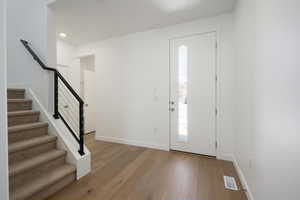 Foyer entrance with light hardwood / wood-style flooring