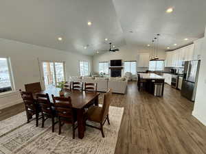 Dining room featuring plenty of natural light, a fireplace, and wood finished floors