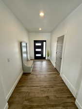 Doorway to outside with recessed lighting, visible vents, dark wood finished floors, and baseboards