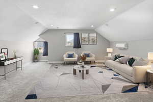 Spacious room with sloped ceilings and recessed lighting