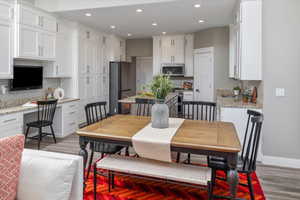 Dining room featuring sink, built in desk, and wood-type flooring