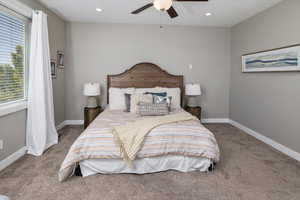 Bedroom featuring dark colored carpet and ceiling fan