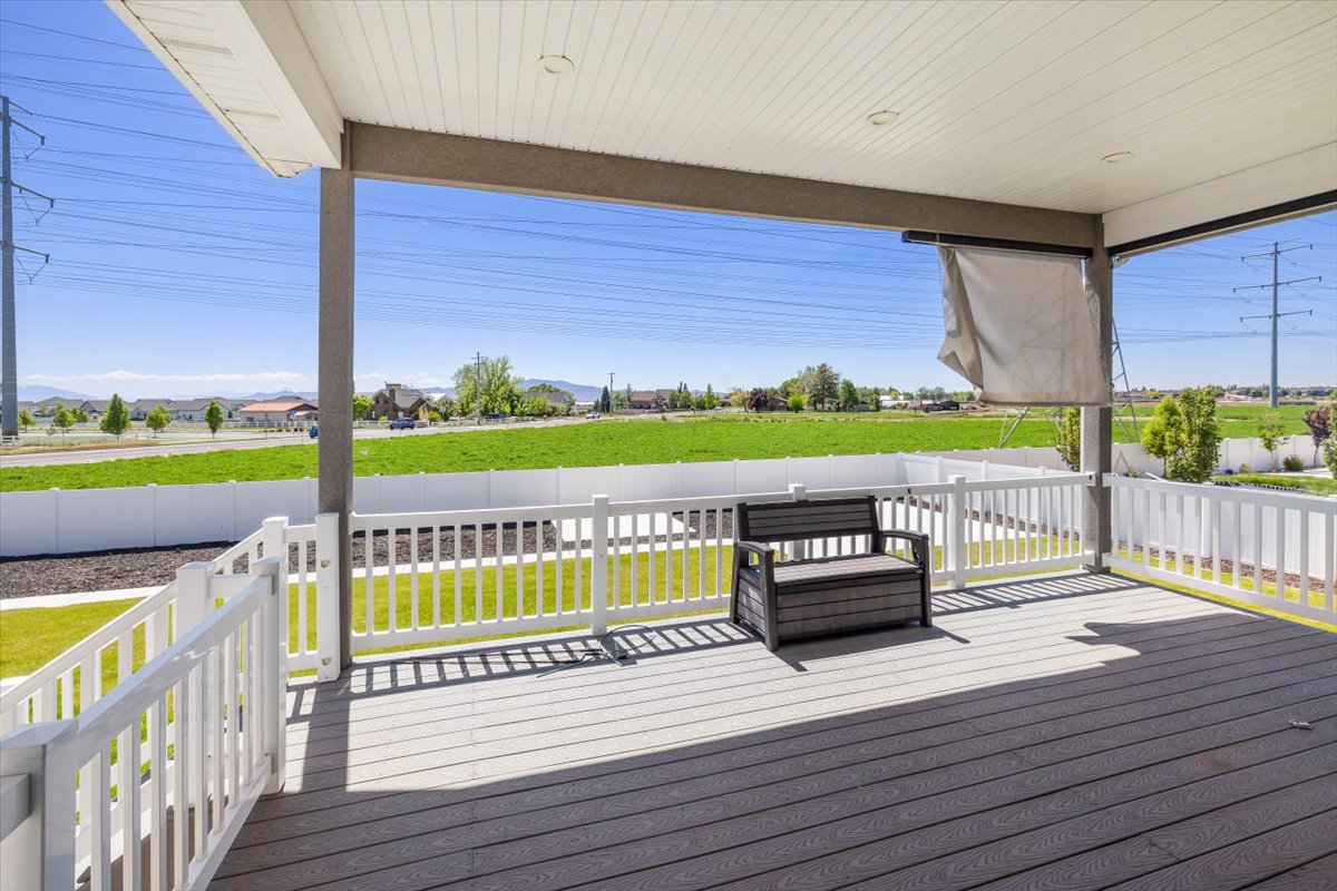 Wooden terrace featuring a yard