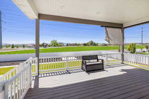 Wooden terrace featuring a yard