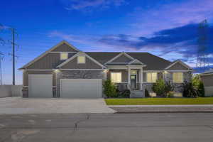 Craftsman house featuring a garage and a yard