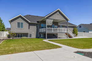 Rear view of house featuring a lawn