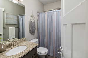 Bathroom featuring oversized vanity and toilet