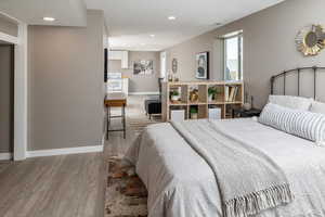 Bedroom with hardwood / wood-style flooring