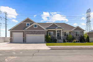 Craftsman-style house featuring a front lawn and a garage