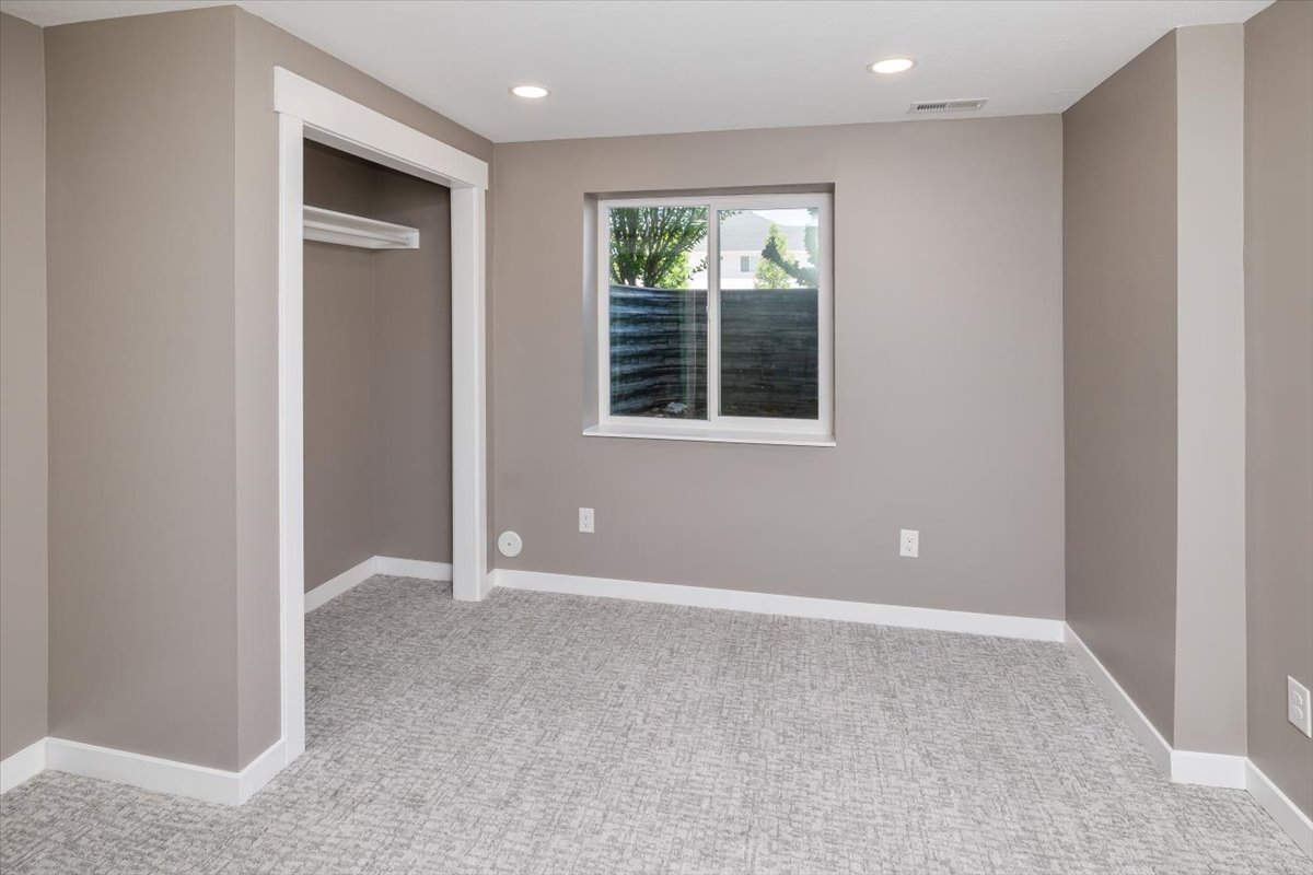 Unfurnished bedroom with a closet and light carpet