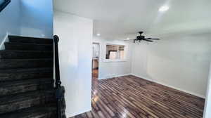 Stairway with dark hardwood / wood-style flooring, ceiling fan, and a textured ceiling