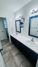 Bathroom with tile floors and dual bowl vanity